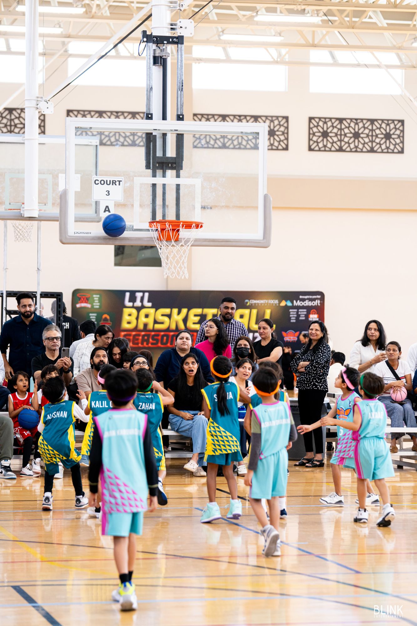 A shot going up at Court 3 with parents along the baseline