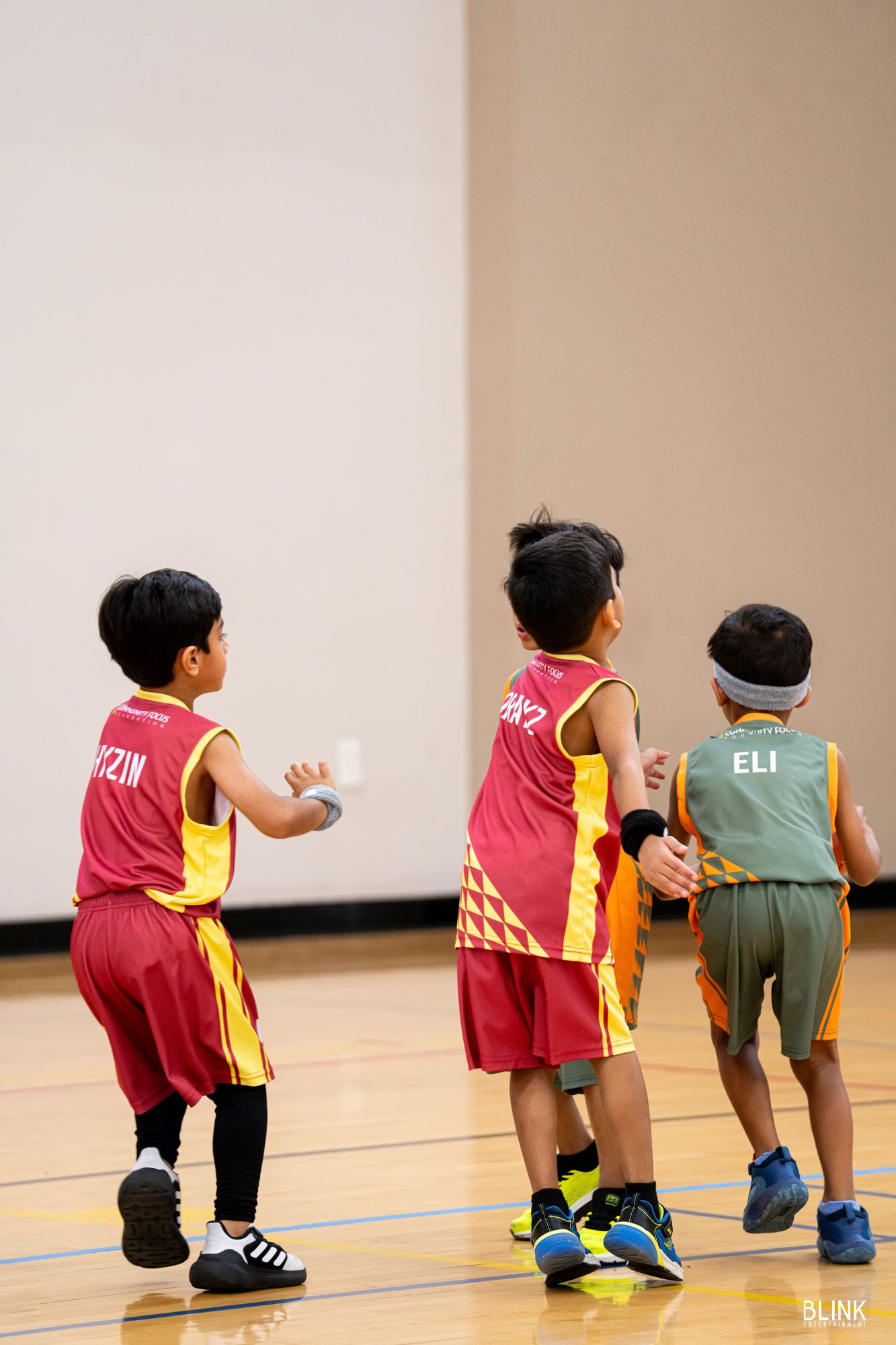 Three players running the floor in a 2025 Li'l Bonanza game