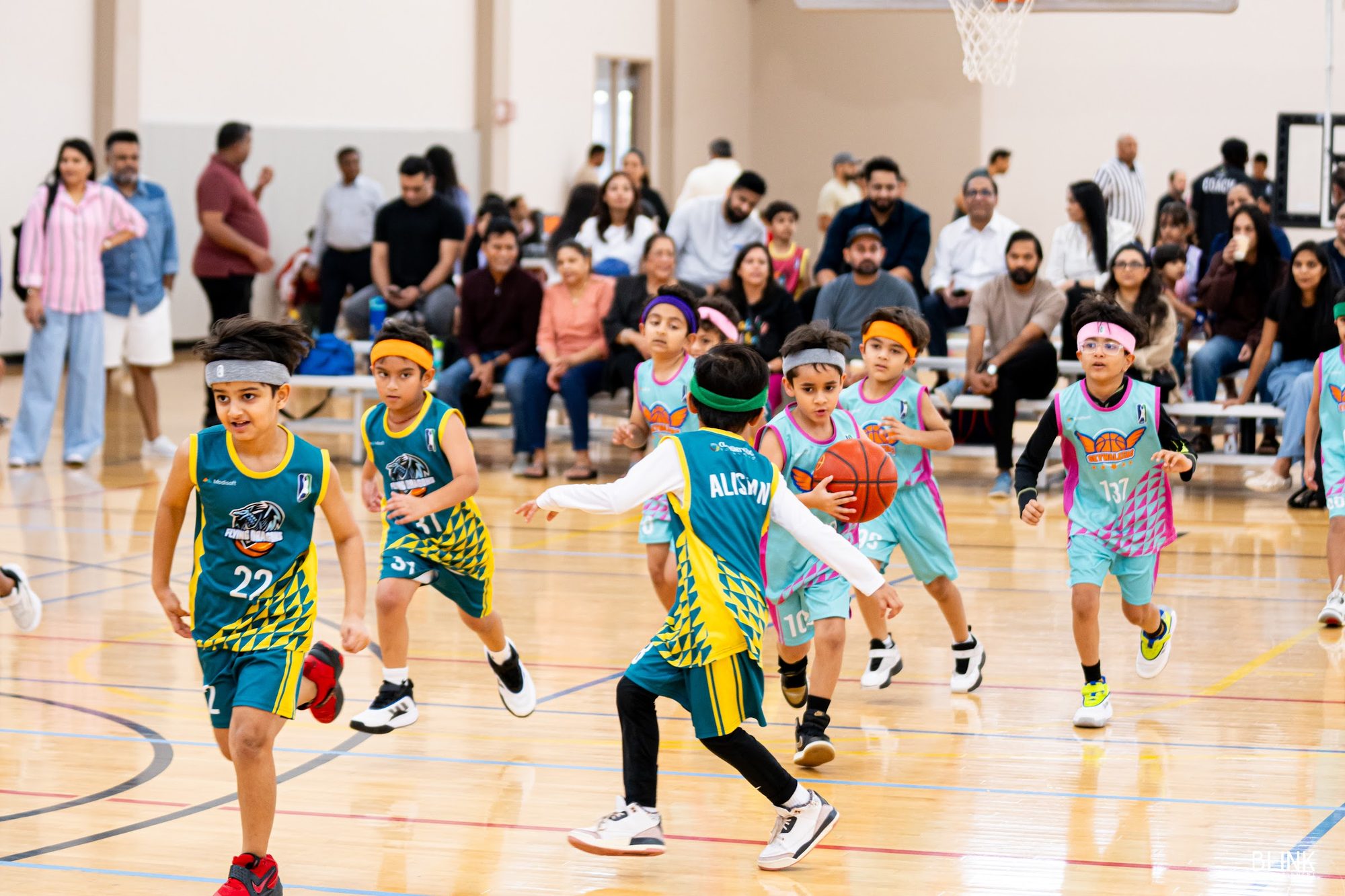 Flying Dragons and Skywalkers run a Sunday game with parents in the bleachers