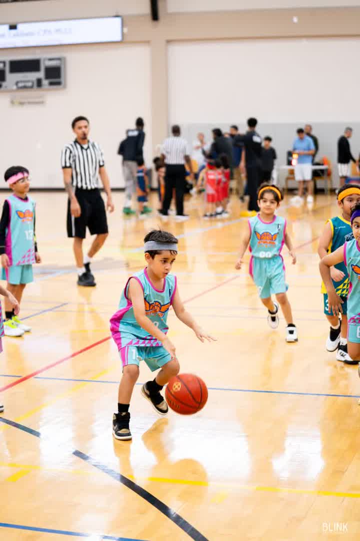 A Season 7 player dribbles on opening Sunday at Pioneer Community Center